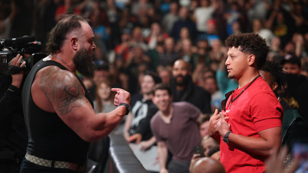 What actions did Patrick Mahomes take at WWE Monday Night Raw besides gifting his Super Bowl rings, still resulted in a positive reaction from the crowd and involved some members of his team?