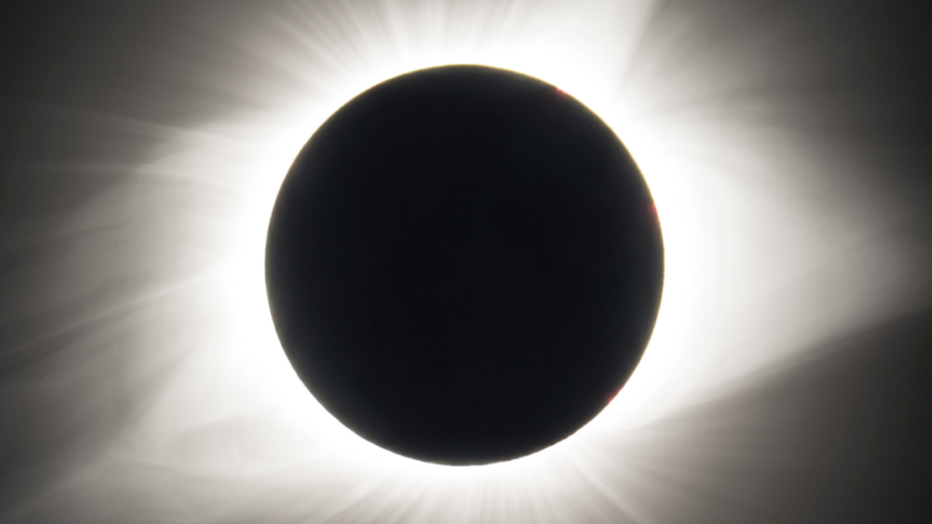 What is a celestial event where the Moon blocks the Sun but makes its corona visible?